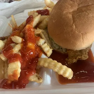 Flounder sandwich with cole slaw and French fries.