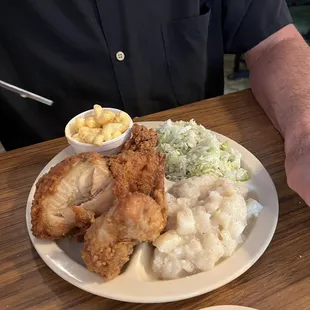 Fried chicken with German potato salad and slaw and Macaroni and cheese.