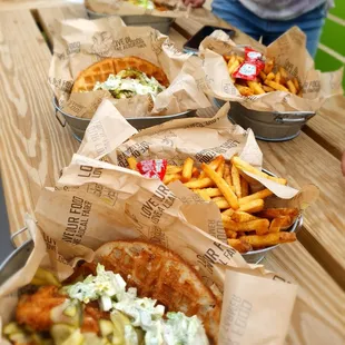  several baskets of food on a picnic table