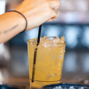  a woman holding a drink