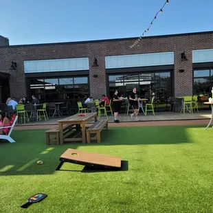  a man throwing a corn hole