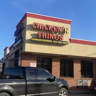 a truck parked in front of a restaurant