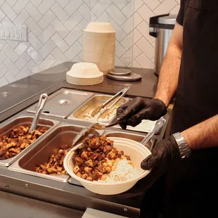 a man preparing food in a buffet