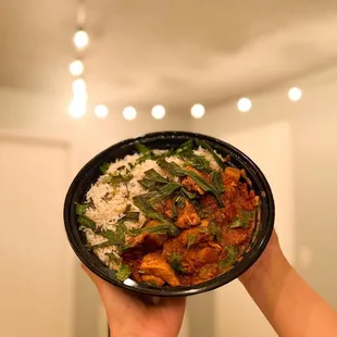 a person holding a bowl of food