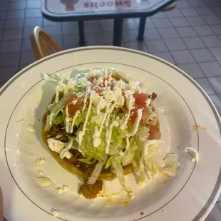 a hand holding a plate of food