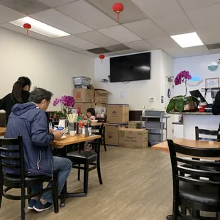 people sitting at tables in a restaurant