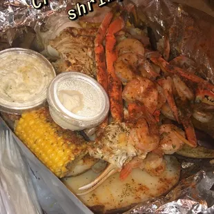 Crab  legs and peel n eat shrimp  corn, potatoes and sausage