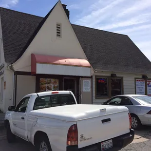 a white truck parked in front of a restaurant