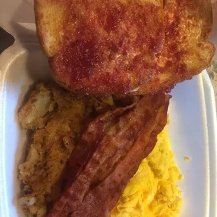 Big Breakfast platter  With bacon, home fries and scrambled eggs and cheese. With butter and jelly toast.