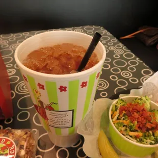 a cup of soup and a bowl of salad