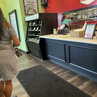 a woman standing in front of a counter