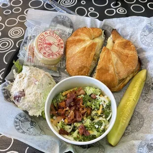Chicken salad melt on a croissant with a side of fruity Fran and broccoli salad.