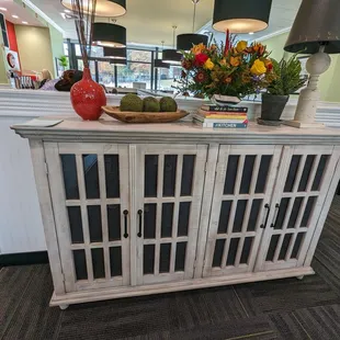 a white cabinet with glass doors