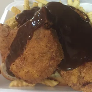 a plate of food with french fries and gravy