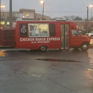 a red truck parked in a parking lot