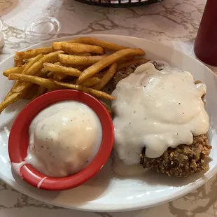 Chicken fried steak dinner with mashed potatoes &amp; French fries