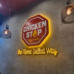 a sign for the flame grilled way