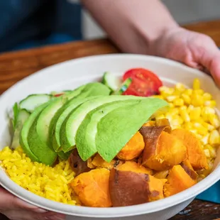 a person holding a bowl of food