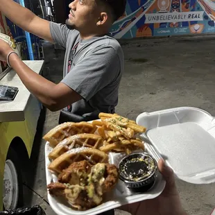a man holding a tray of food