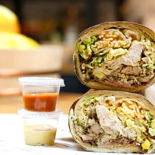 two burritos on a table