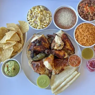 Chicken meal, chips &amp; guacamole, macaroni salad, rice, whole beans, refried beans + salsas