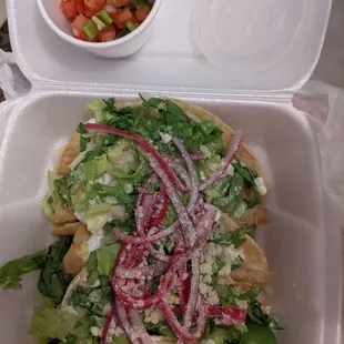 a salad in a styrofoam container