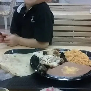 2 Piece chicken with rice and refried beans and flour tortilas