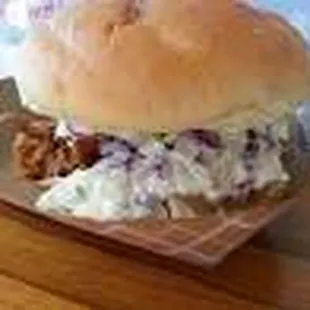 This is our signature sandwich pulled pork with slaw and sliced smoke sausage on top