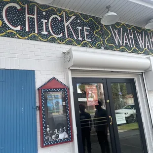 a man standing in front of a restaurant