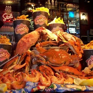 a pile of crab legs and shrimp