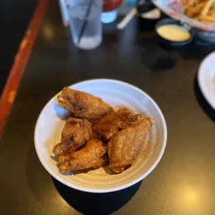 a plate of chicken wings and fries