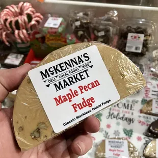a hand holding a bag of maple pecan fudge