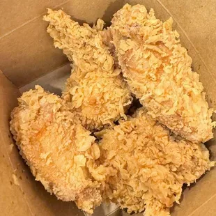 a close up of a box of fried chicken