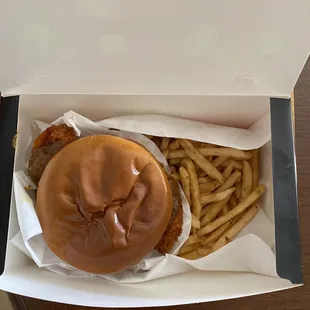 Chicken sandwich with honey orange sauce with a side of fries