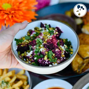 a person holding a bowl of food