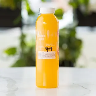 a bottle of orange juice on a table