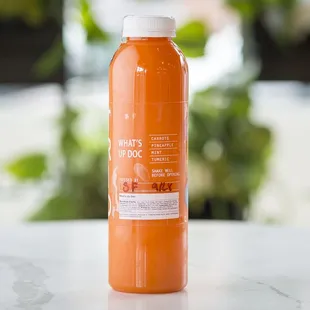 a bottle of orange juice on a table
