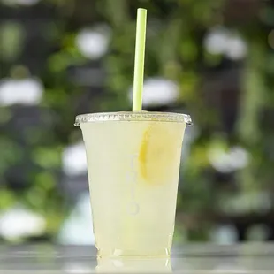 a drink in a plastic cup with a straw