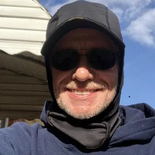 a man wearing a hat and sunglasses