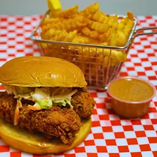 a basket of fries and a fried chicken sandwich