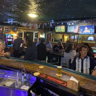 a group of people sitting at a bar