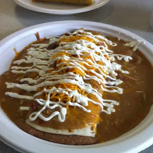 Bean Burrito smothered with Green Chili, Cheese, Sour Cream and Chicharróns