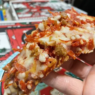 Slice of combination pizza.