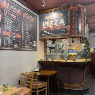 a restaurant with a menu on the wall