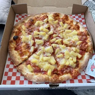 Small pineapple pizza light on the cheese