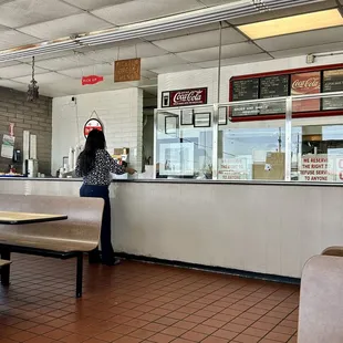 a woman standing at the counter