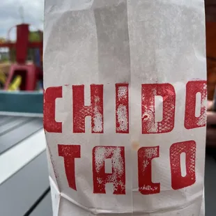 a paper bag with the word chido taco on it