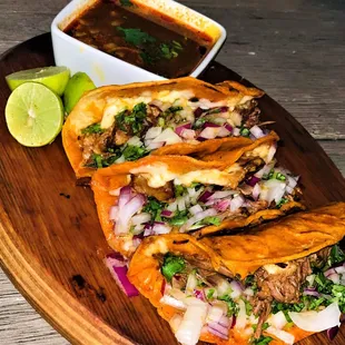 three tacos on a wooden platter