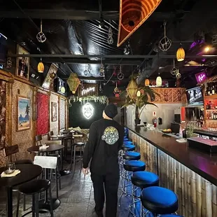 a man walking through the bar