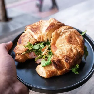 a croissant sandwich on a plate